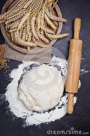 Baking background with flour, rolling pin and grain ears on black chalkboard Stock Photo