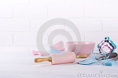 Baking background with kitchen tools: rolling pin, wooden spoons, whisk, sieve, bakeware and shape cookie cutter on white Stock Photo