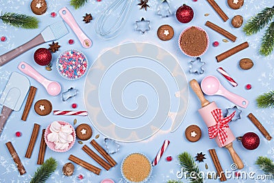 Christmas spices, cookie cutters, ingredients for christmas baking and kitchen utensils gingerbread cookies on blue pastel backgro Stock Photo