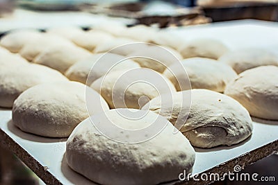 Baking dough and preparing bread loaves Stock Photo