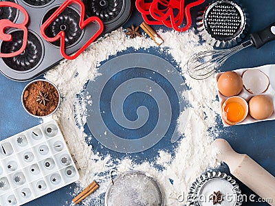 Baking flour frame on dark blue with tools ingredients Stock Photo