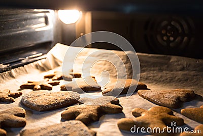 Baking gingerbread cookies for Christmas in the oven Stock Photo