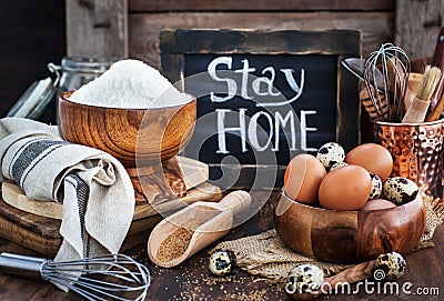 Baking ingredients and board with notice stay at home Stock Photo