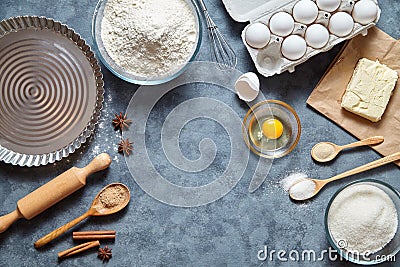 Baking ingredients for homemade pastry on dark background. Bake sweet cake dessert concept. Top view, flat lay Stock Photo