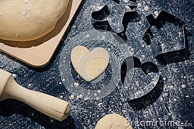 Baking love heart cookies for Valentine day. Top view. Making heart shaped cookies with cutters Stock Photo