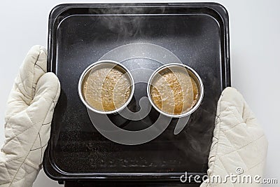 Baking muffin egg in cup by hands on black tray Stock Photo