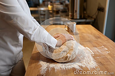 Baking process, closeup baker hands kneading dough on table Stock Photo