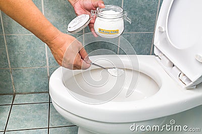 Baking soda used to clean and disinfect bathroom and toilet bowl Stock Photo