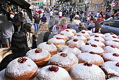 Baking tray full of fresh Sufganiyot Israeli doughnuts Editorial Stock Photo