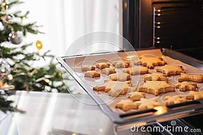 Baking tray with ginger Christmas cookies snowflakes in the oven Stock Photo