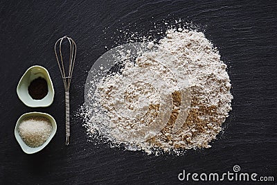 Baking utensils flour and mixer on dark surface Stock Photo