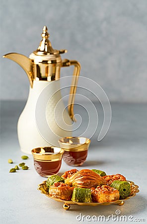 Baklava sweets with Arabic Coffee pot Dallah and cup of traditional cardamon coffee Qahwa Stock Photo