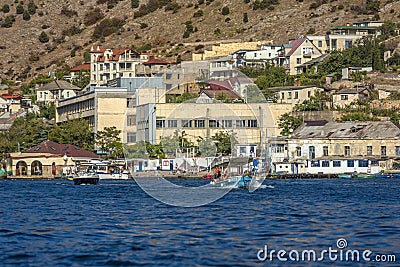 Old and modern buildings on the embankment of the Black Sea bay. Boat, cars Editorial Stock Photo