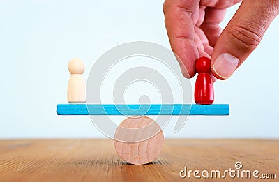 Balance concept. Red person figure on seesaw Stock Photo