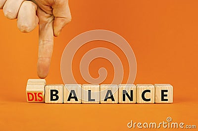 Balance or disbalance symbol. Concept word Disbalance or Balance on beautiful wooden cubes. Beautiful orange background. Stock Photo