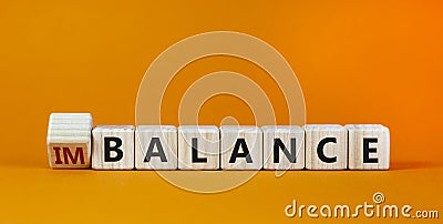 Balance or imbalance symbol. Turned cubes and changed the word imbalance to balance. Beautiful orange background, copy space. Stock Photo