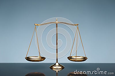 Balance scale on blue background Stock Photo