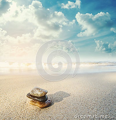 Balance stone on the beach in sunrise, vintage tone Stock Photo