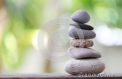 Balance Stones stacked to pyramid in the soft green background. Stock Photo