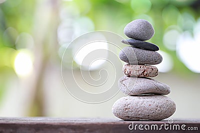 Balance Stones stacked to pyramid in the soft nature green background. Stock Photo