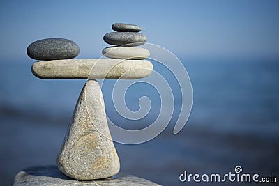Balance of stones. To weight pros and cons. Balancing stones on the top of boulder. Close up. Stock Photo