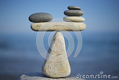 Balance of stones. To weight pros and cons. Balancing stones on the top of boulder. Close up. Stock Photo