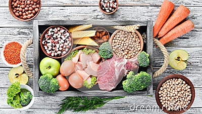 Balanced diet food background. Meat, chicken fillet, broccoli, beans, cheese, eggs, wheat. Stock Photo