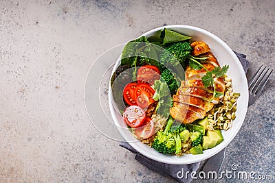 Balanced food concept. Chicken, broccoli and quinoa salad in white bowl, gray background, top view Stock Photo