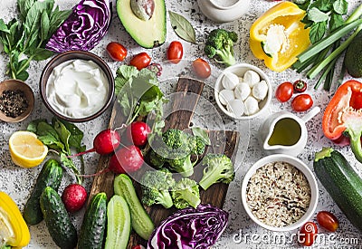 Balanced healthy diet food background in a Mediterranean style. Fresh vegetables, wild rice, fresh yogurt and goat cheese on a lig Stock Photo