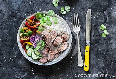 Balanced power buddha bowl - grilled beef steak, roasted and fresh vegetables, rice on a dark background, top view. Healthy diet Stock Photo