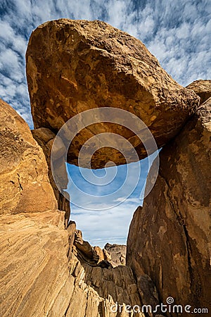 Balanced Rock Precariously Perched Over Narrow Tunnel Stock Photo