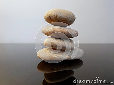 Balanced zen stones on a black table. Stock Photo