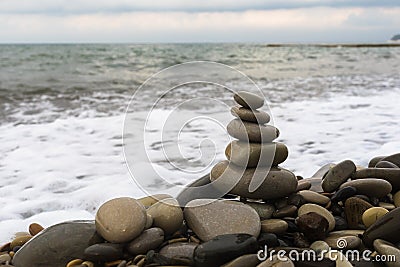 Balancing pyramid of sea stones on a pebble beach Stock Photo