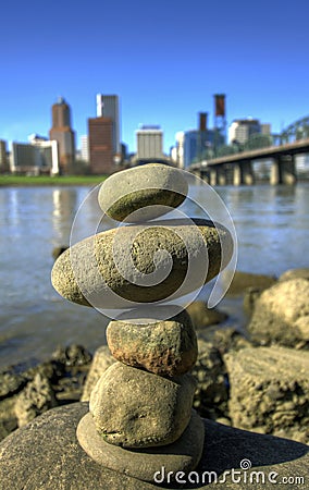 Balancing Rocks against City Skyline Stock Photo