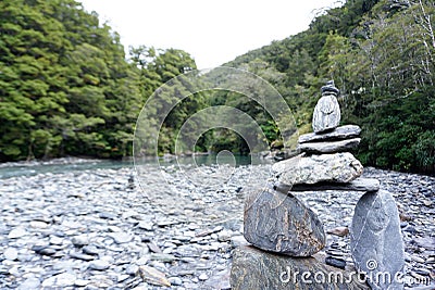 Balancing stone with river and mountain background Stock Photo