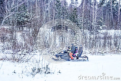 Balashiha, Russia - 4 september 2021 : Family Riding a snowmobile in the forest. Editorial Stock Photo