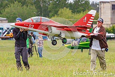 Balashikha, Moscow region, Russia - May 25, 2019: Team members of Aviation Sports Club RusJet carry a RC model of Russian jet Editorial Stock Photo