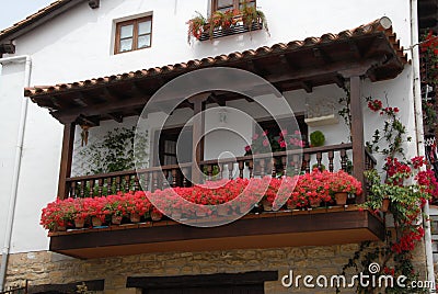 Balcony with flowers of tipical house in Santillana del Mar Stock Photo