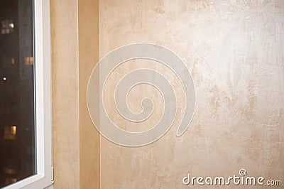 On the balcony in the apartment Venetian decorative plaster with golden glittering paint. Background, abstraction Stock Photo