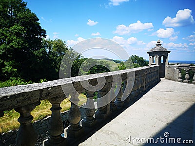 Balcony of a fabulous palace in classical style with a view of the green landscape Stock Photo