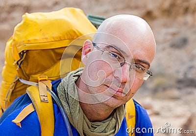 Bald man backpacker mountaineer tourist looking at camera portrait Stock Photo