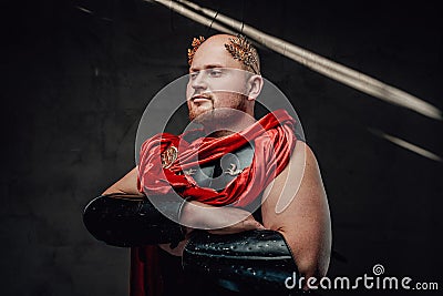 Bald roman warrior poses with crossed arms in dark background Stock Photo