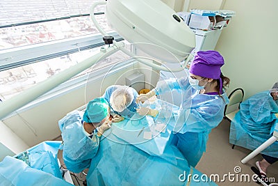 Baldness treatment. Hair transplant. Surgeons in the operating room carry out hair transplant surgery. Surgical Stock Photo