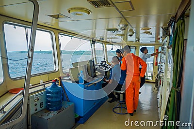 BALI, INDONESIA - APRIL 05, 2017: Ferry boat pilot command cabin with the captain operating the machines with a many Editorial Stock Photo