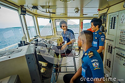 BALI, INDONESIA - APRIL 05, 2017: Ferry boat pilot command cabin with view on the sea with many assistants there in Ubud Editorial Stock Photo