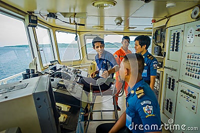 BALI, INDONESIA - APRIL 05, 2017: Ferry boat pilot command cabin with view on the sea with many assistants there in Ubud Editorial Stock Photo