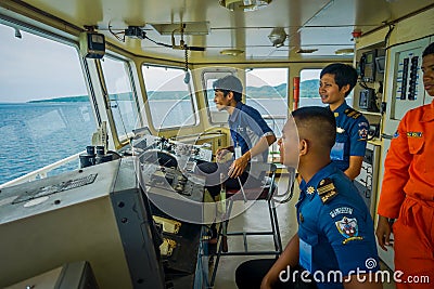 BALI, INDONESIA - APRIL 05, 2017: Ferry boat pilot command cabin with view on the sea with many assistants there in Ubud Editorial Stock Photo