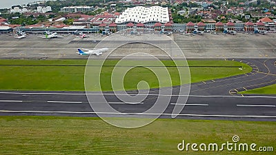 Bali, Indonesia, December 4, 2020. Aerial view of airplanes at the airport runway. Indonesian budget airline, Garuda Indonesia Editorial Stock Photo