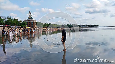 Bali, Indonesia - Kuta beach visitors take part in the activity of releasing baby turtles into the sea - September 16, 2023 Editorial Stock Photo