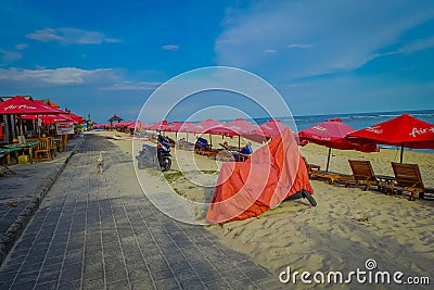 BALI, INDONESIA - MARCH 11, 2017: Beautiful sunny day with a small typical food stores outside with a row of red Editorial Stock Photo